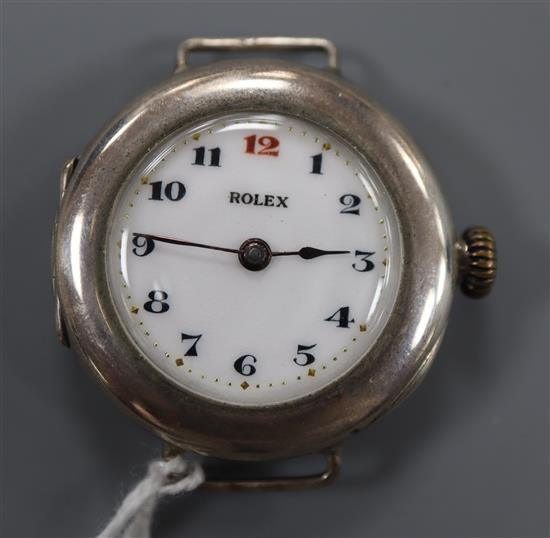 An early 20th century silver Rolex manual wind wrist watch with detached sterling flexible bracelet strap.